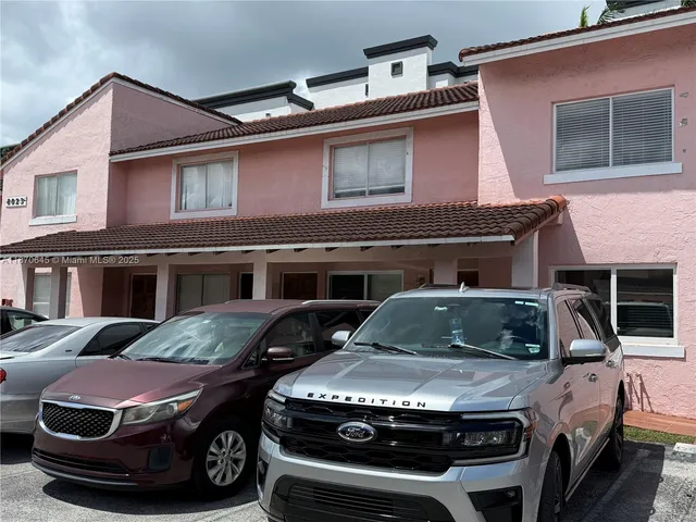 a front view of a house with parking space