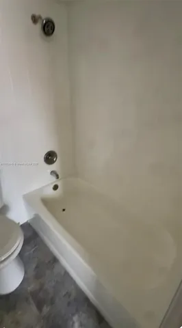a bathroom with a bathtub and toilet