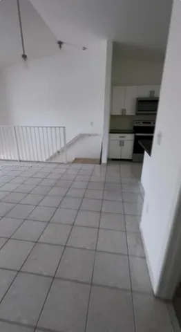 a view of a livingroom with an empty space and a window