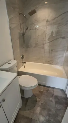 a bathroom with a toilet a sink and bathtub