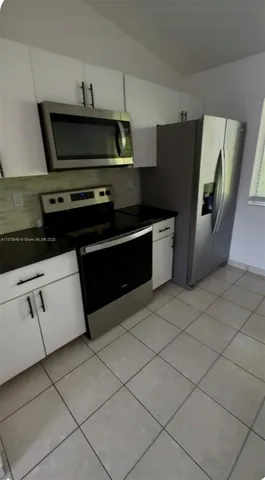 a kitchen with appliances and cabinets