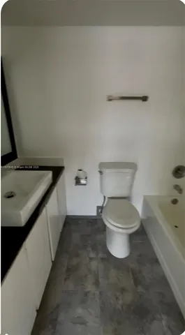 a bathroom with a sink toilet and tub
