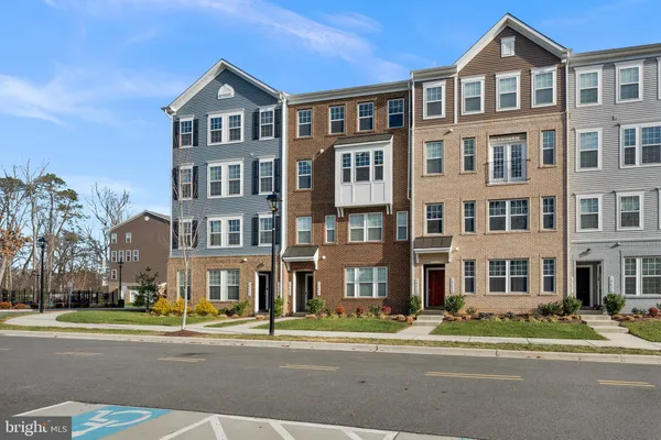 a front view of a residential apartment building with a yard