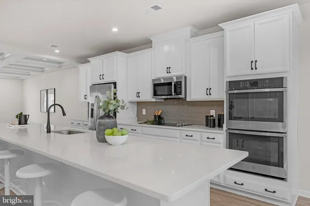 a kitchen with a sink a stove and cabinets