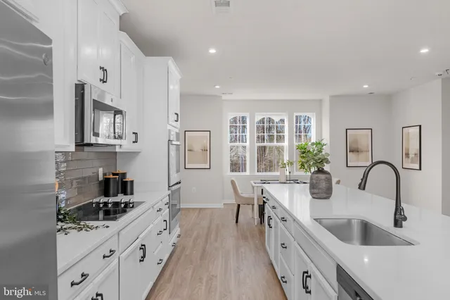 a kitchen with sink a stove and cabinets