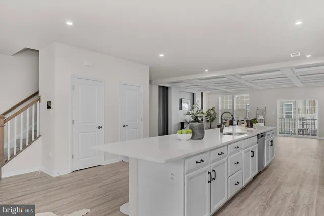 a kitchen with counter top space and wooden floor