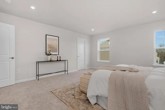 a bedroom with a bed and a night stand