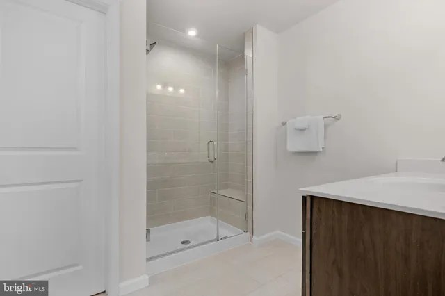 a bathroom with a shower and a sink