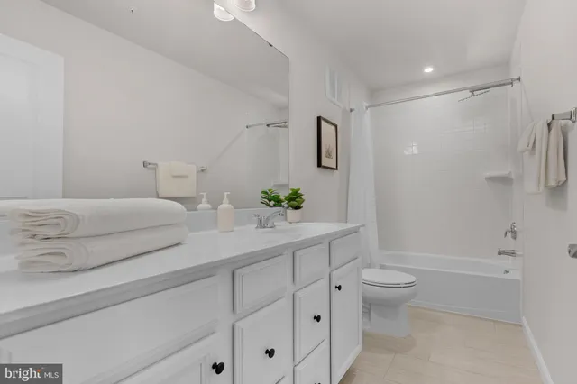 a bathroom with a double vanity sink toilet and shower