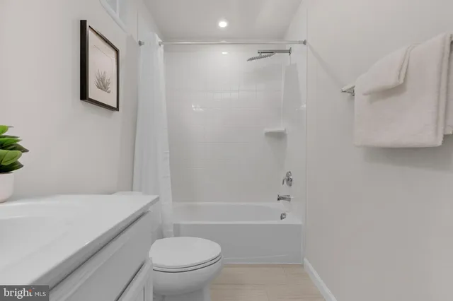 a bathroom with a toilet and a tub