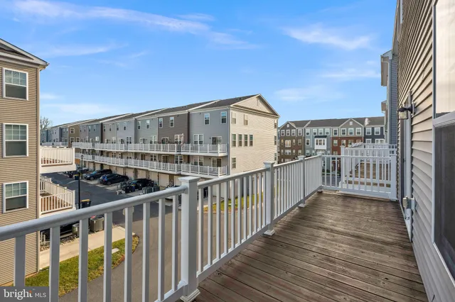 a view of a balcony with wooden floor and fence