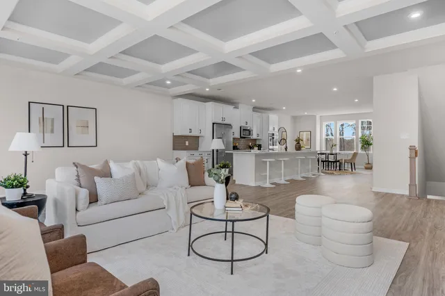a living room with furniture and kitchen view