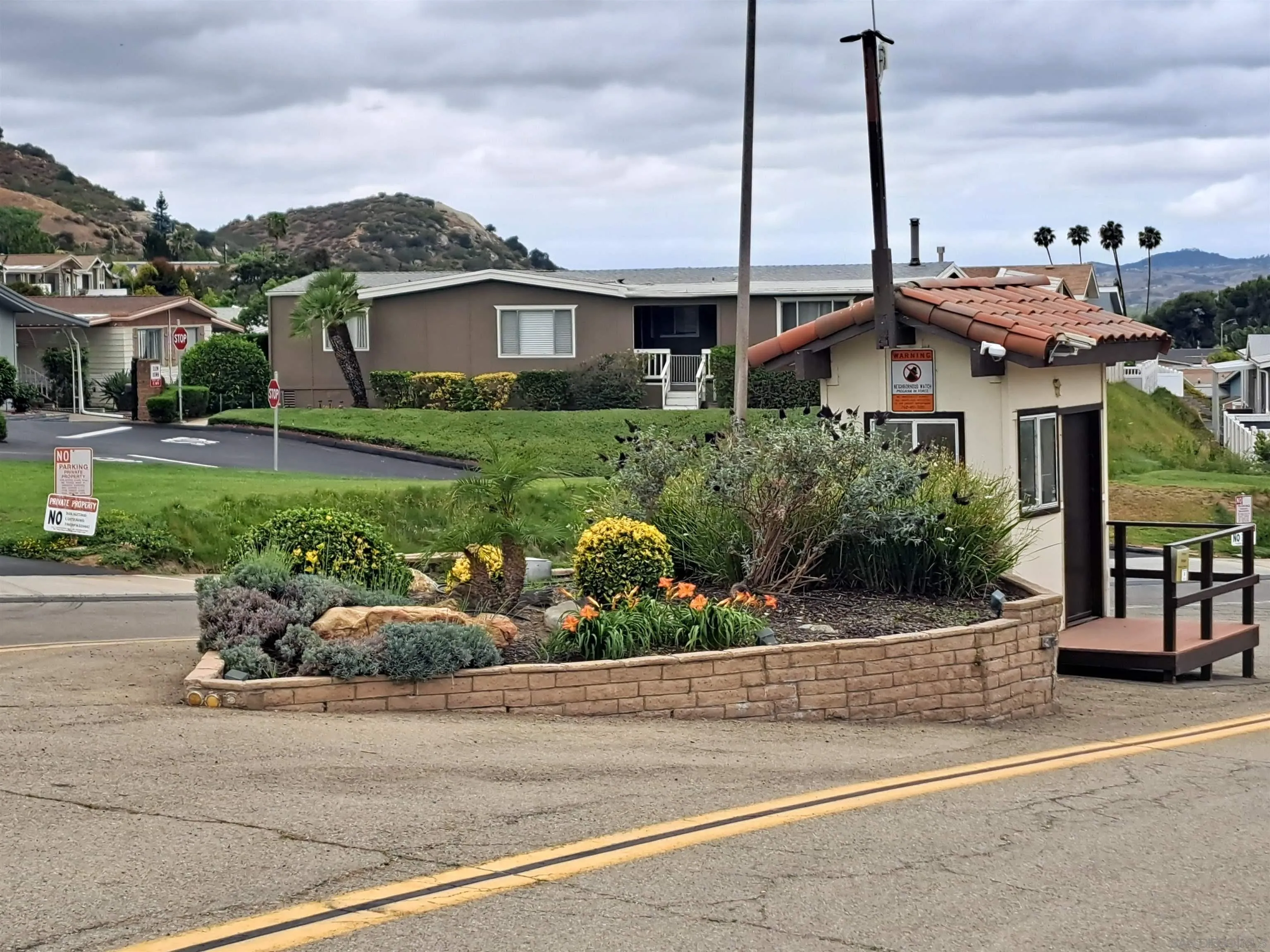 4650 Dulin Road, Unit 12 Fallbrook, CA 92003 - Photo 26 of 36 a front view of a house with a garden and plants