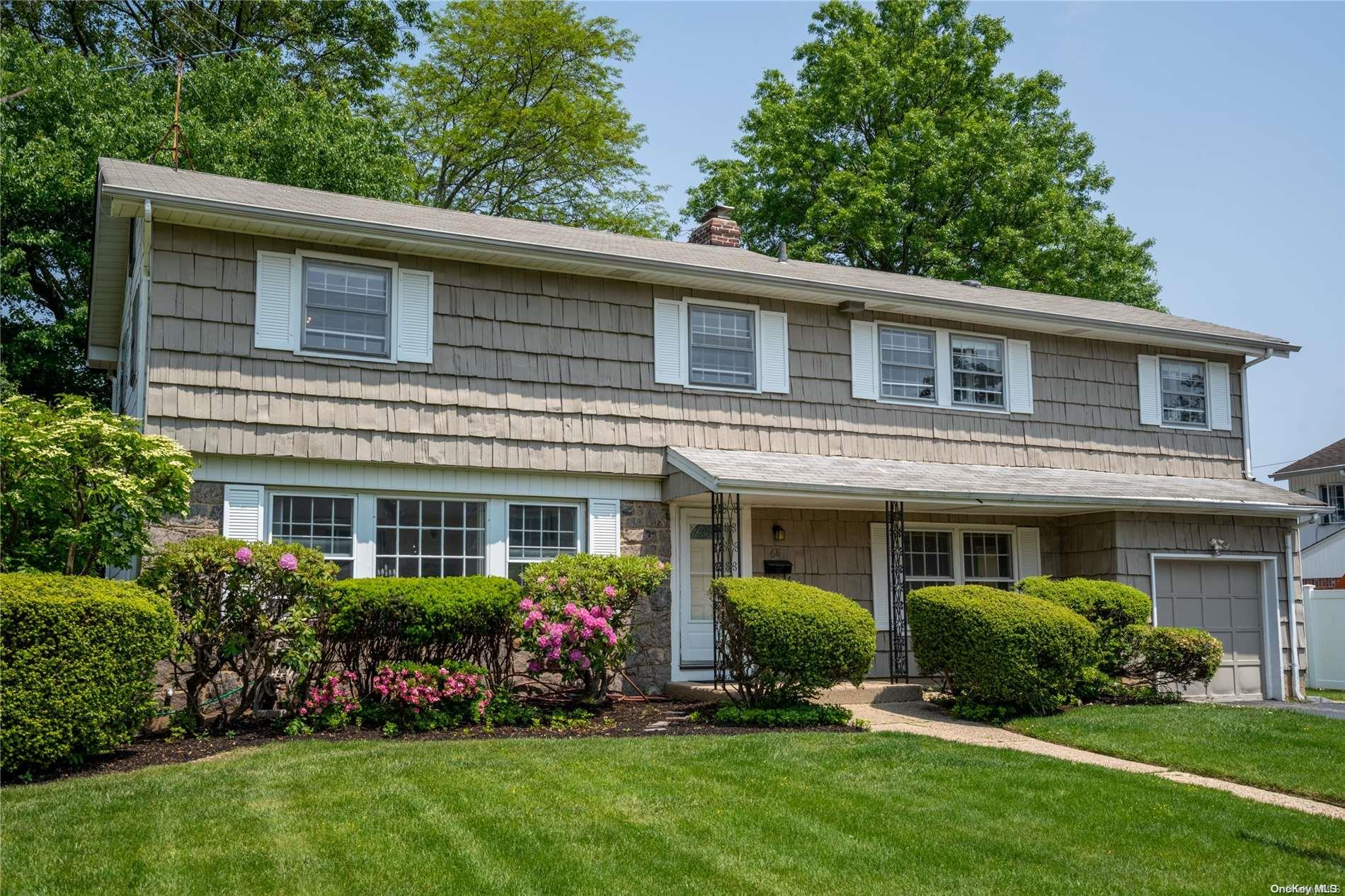 a front view of a house with a yard table and chairs