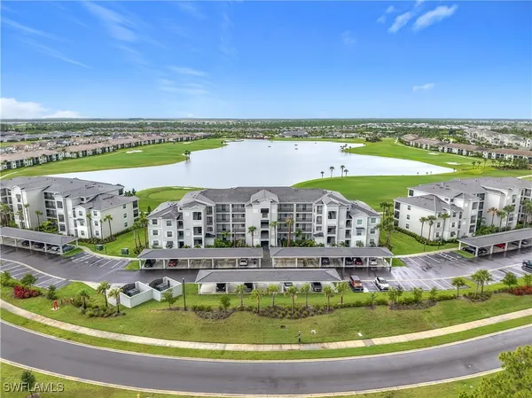an aerial view of a house with a garden and lake view