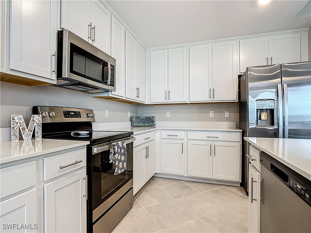 43981 Boardwalk Loop, Unit 2222 Punta Gorda, FL 33982 - Photo 11 of 50 a kitchen with stainless steel appliances granite countertop a sink stove and refrigerator