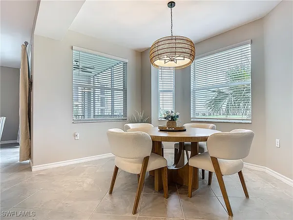 a dining room with furniture and a large window