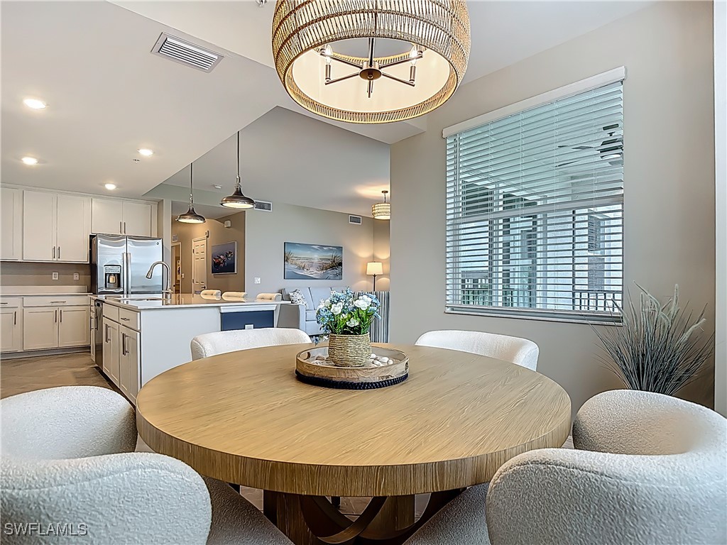 43981 Boardwalk Loop, Unit 2222 Punta Gorda, FL 33982 - Photo 16 of 50 a dining room with furniture and a large window