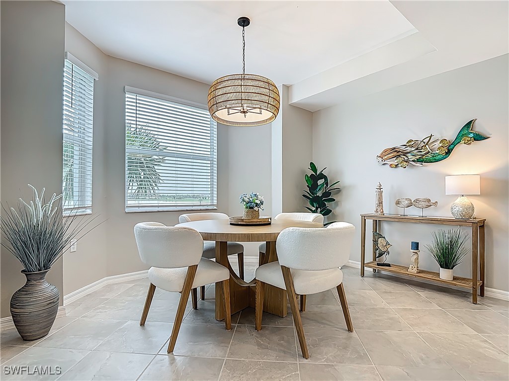 43981 Boardwalk Loop, Unit 2222 Punta Gorda, FL 33982 - Photo 17 of 50 a dining room with furniture potted plants and a chandelier