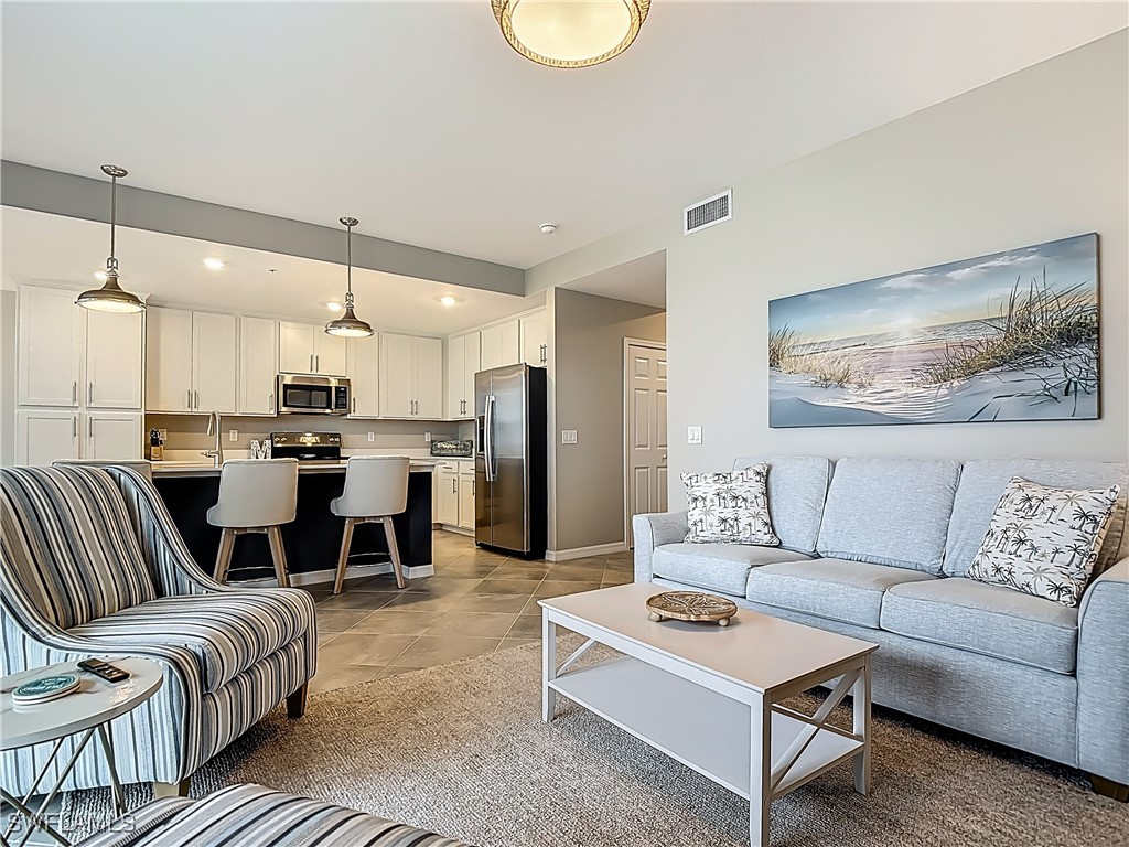 43981 Boardwalk Loop, Unit 2222 Punta Gorda, FL 33982 - Photo 19 of 50 a living room with furniture kitchen view and a wooden floor
