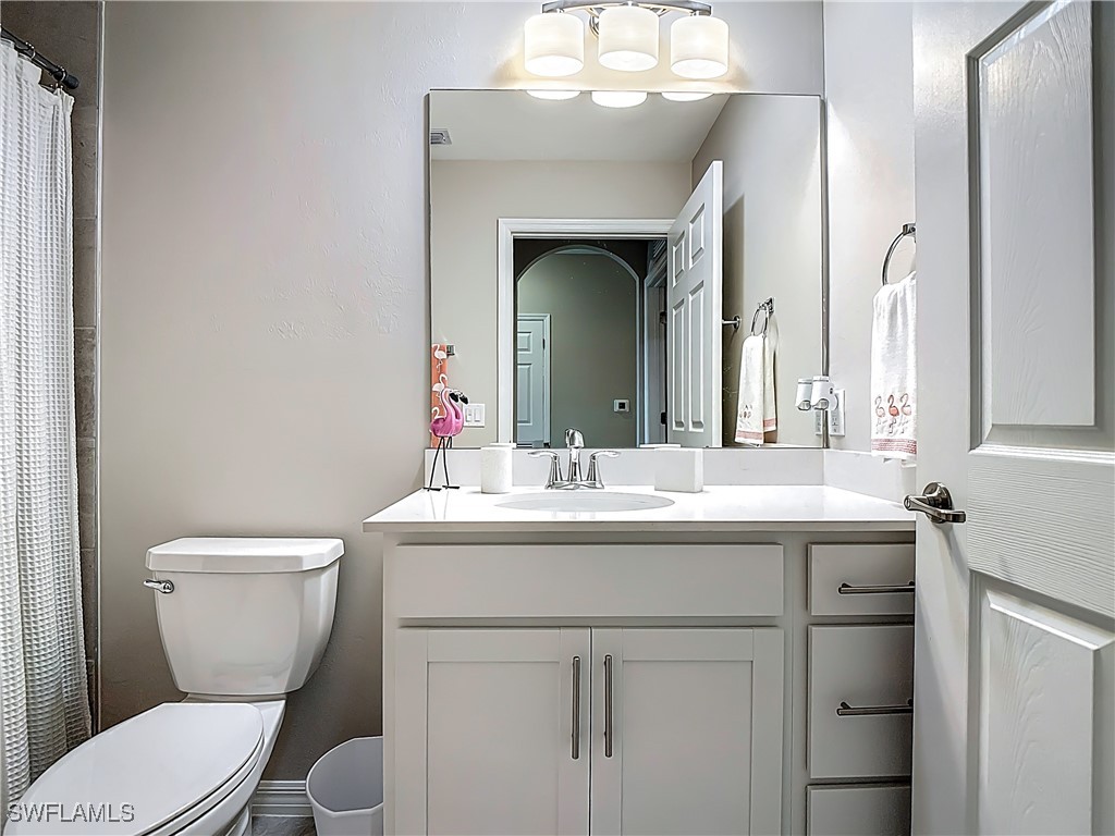 43981 Boardwalk Loop, Unit 2222 Punta Gorda, FL 33982 - Photo 22 of 50 a bathroom with a granite countertop toilet a sink and a mirror