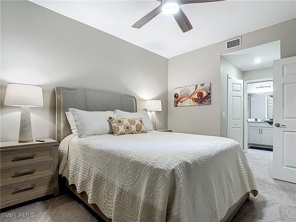 43981 Boardwalk Loop, Unit 2222 Punta Gorda, FL 33982 - Photo 24 of 50 a bedroom with a bed and a chandelier