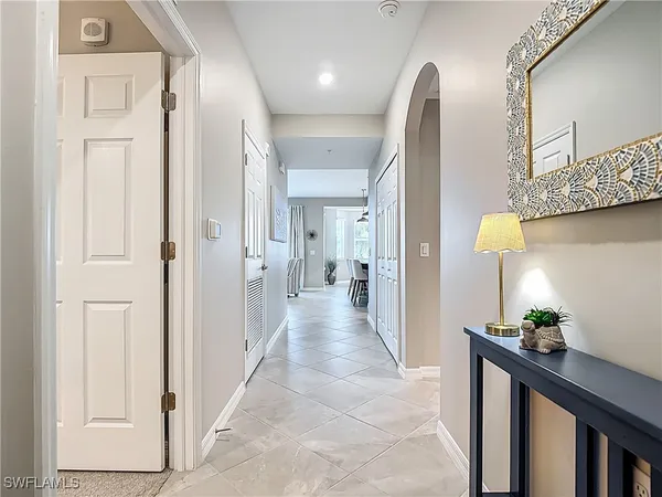 a view of a hallway to a livingroom with furniture