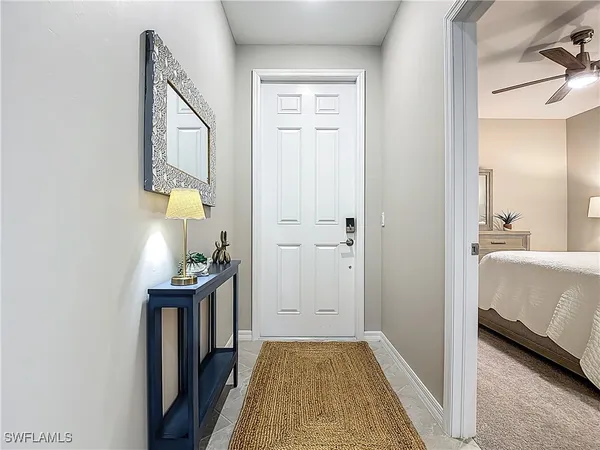 a view of hallway with livingroom and furniture