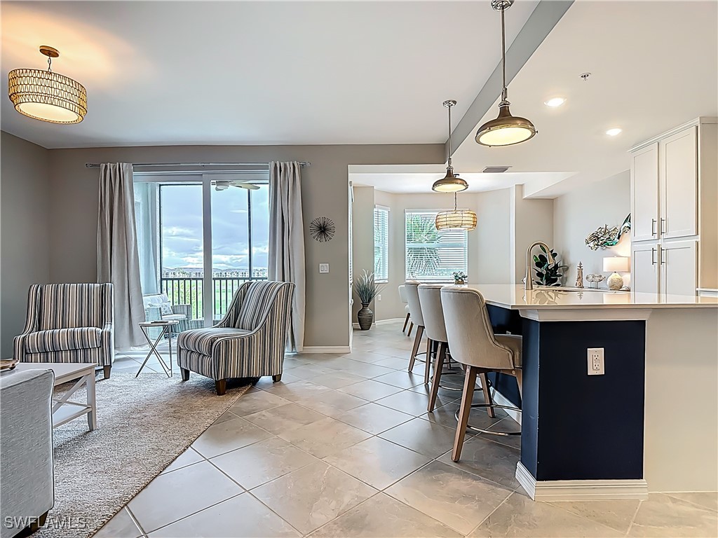 43981 Boardwalk Loop, Unit 2222 Punta Gorda, FL 33982 - Photo 6 of 50 a view of a dining room with furniture wooden floor and chandelier