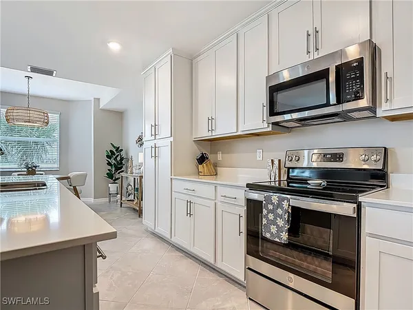 a kitchen with stainless steel appliances a sink stove and cabinets