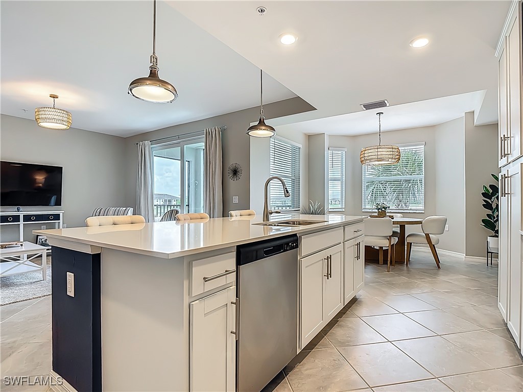 43981 Boardwalk Loop, Unit 2222 Punta Gorda, FL 33982 - Photo 10 of 50 an open kitchen with a sink and chairs