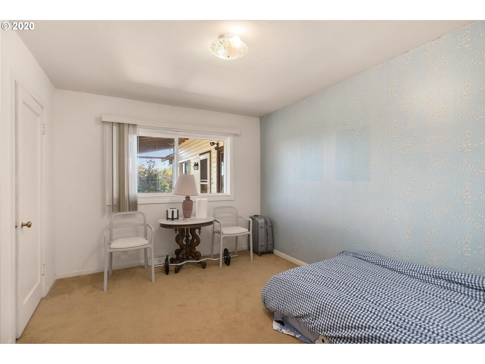 7110 Southwest Straughan Road Hillsboro, OR 97123 - Photo 13 of 28 a bedroom with a bed and a window