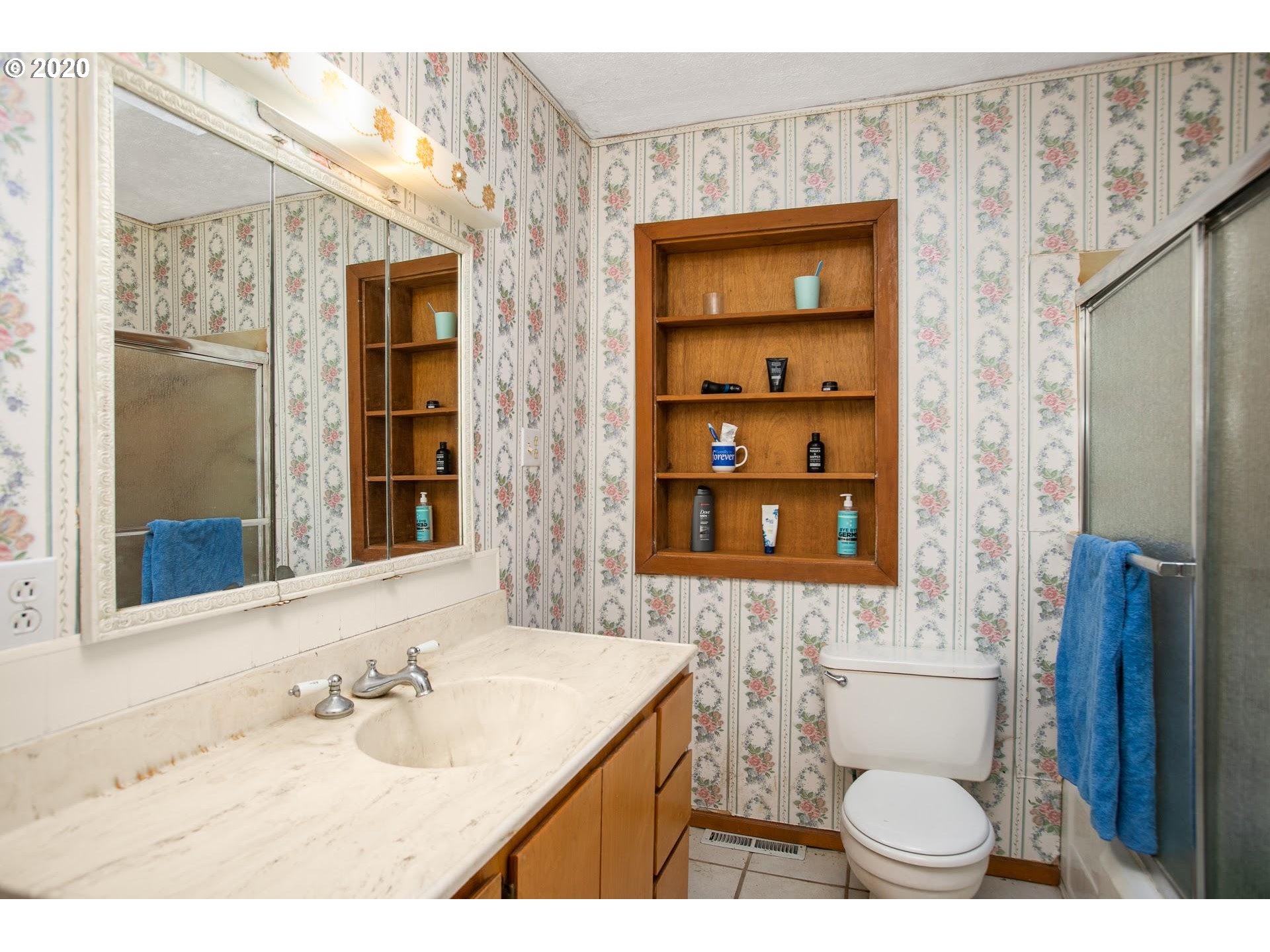 7110 Southwest Straughan Road Hillsboro, OR 97123 - Photo 15 of 28 a bathroom with a granite countertop sink a toilet and shower