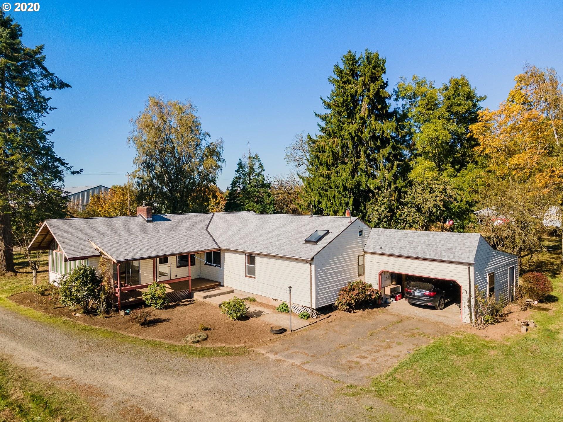 7110 Southwest Straughan Road Hillsboro, OR 97123 - Photo 2 of 28 an aerial view of a house with yard and garage