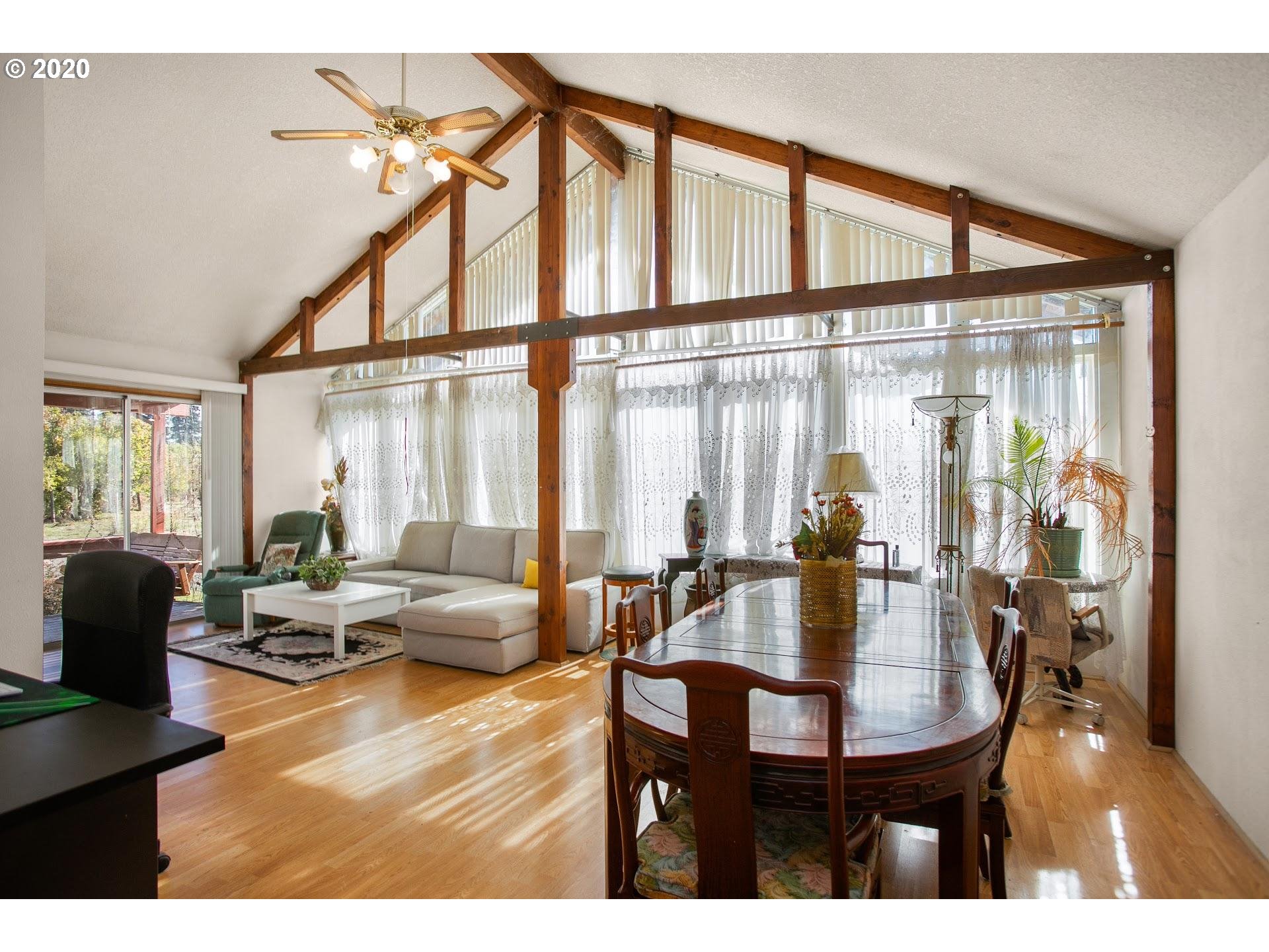 7110 Southwest Straughan Road Hillsboro, OR 97123 - Photo 4 of 28 a dining room with furniture window and wooden floor