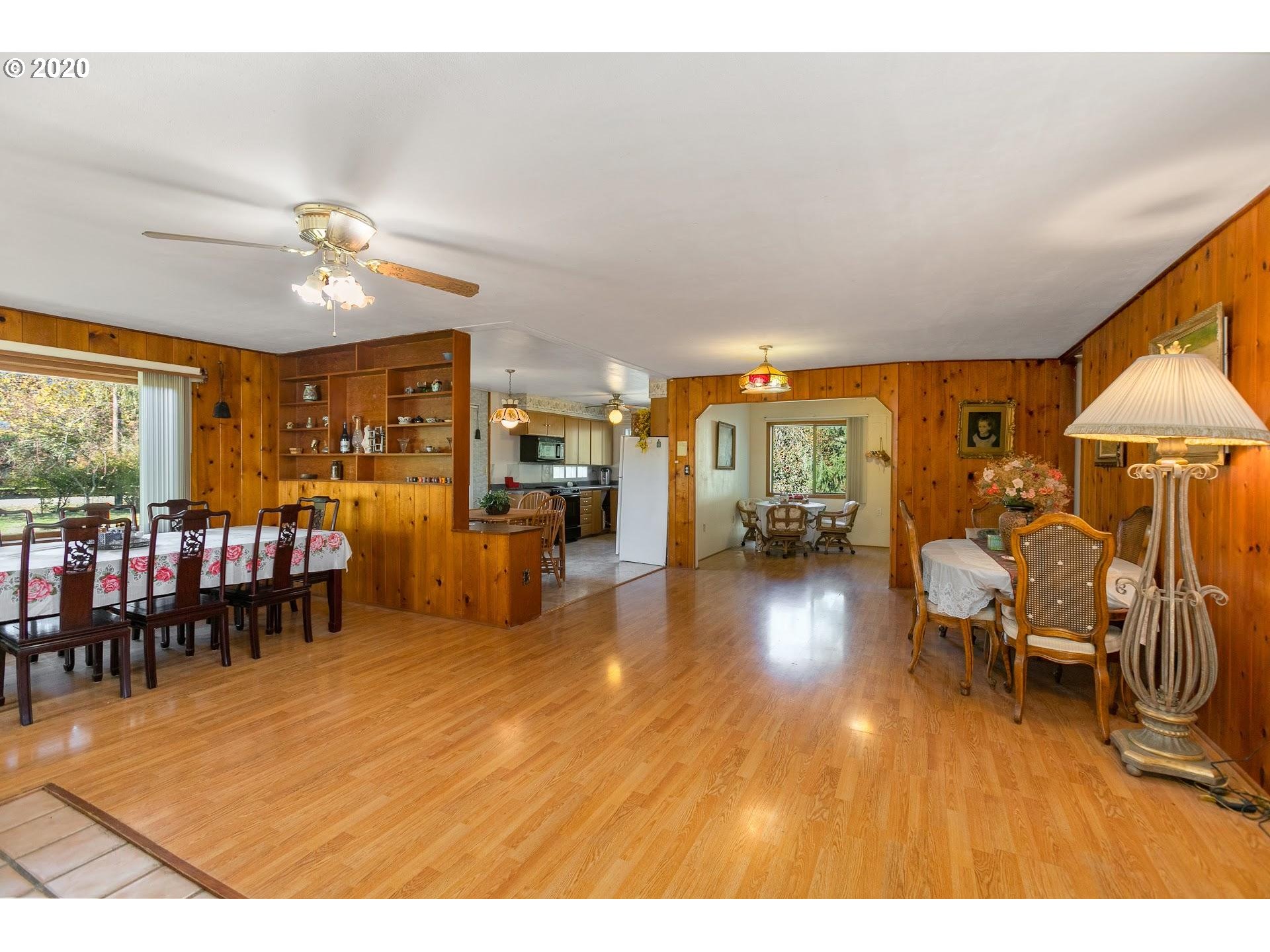 7110 Southwest Straughan Road Hillsboro, OR 97123 - Photo 7 of 28 a living room with furniture and a wooden floor