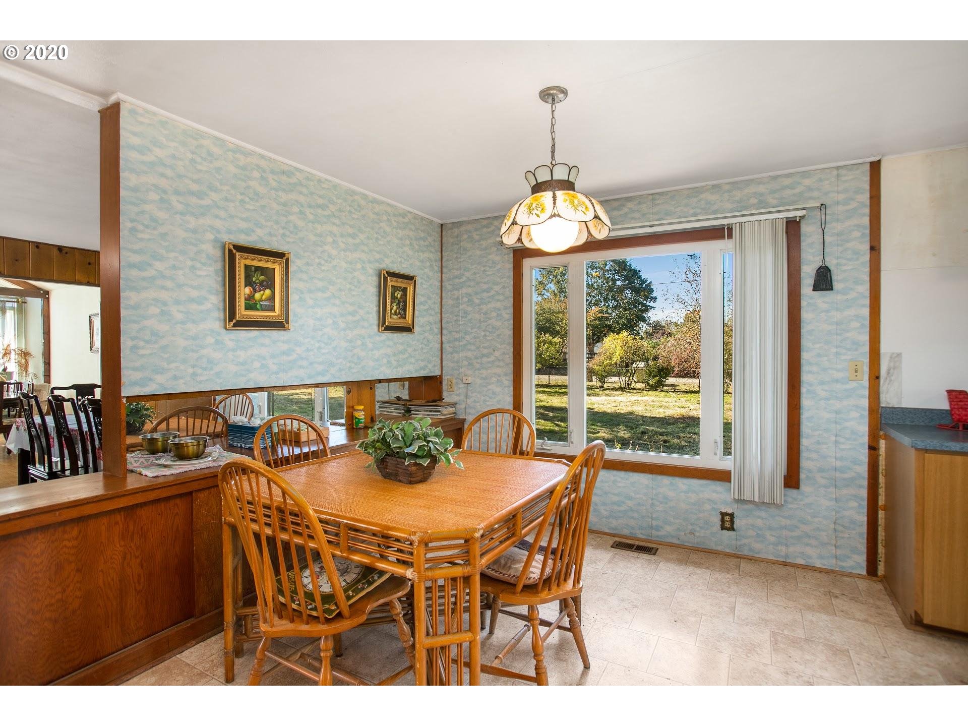 7110 Southwest Straughan Road Hillsboro, OR 97123 - Photo 8 of 28 a view of a dining room with furniture wooden floor and chandelier