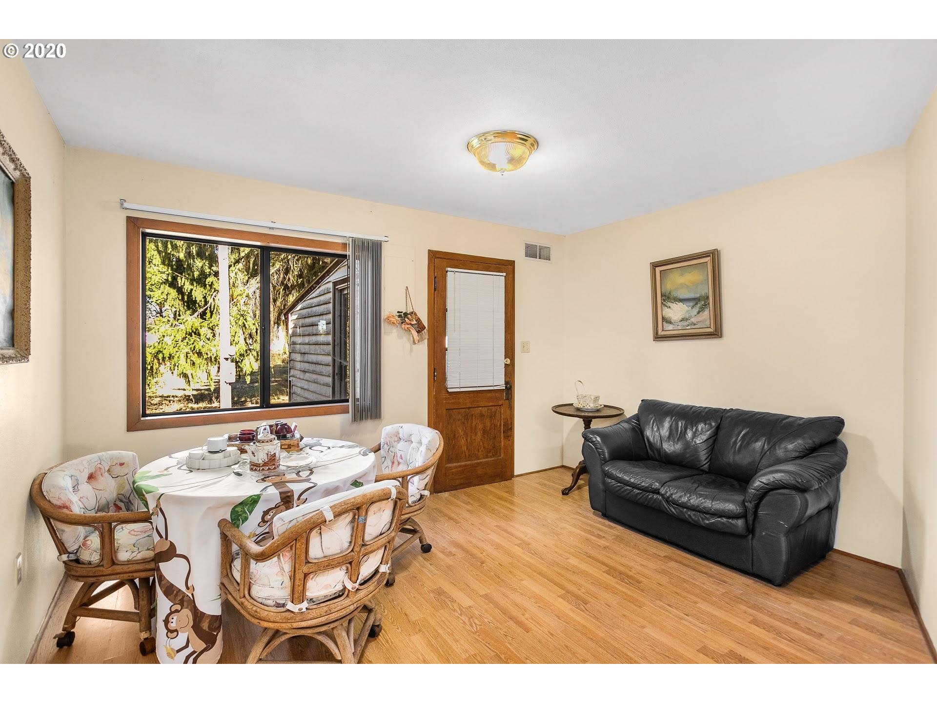 7110 Southwest Straughan Road Hillsboro, OR 97123 - Photo 10 of 28 a living room with furniture and a large window