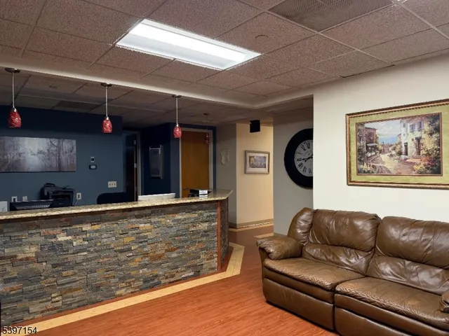 a living room with furniture a flat screen tv and a stove