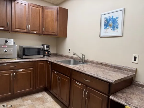 a kitchen with a sink cabinets and wooden floor