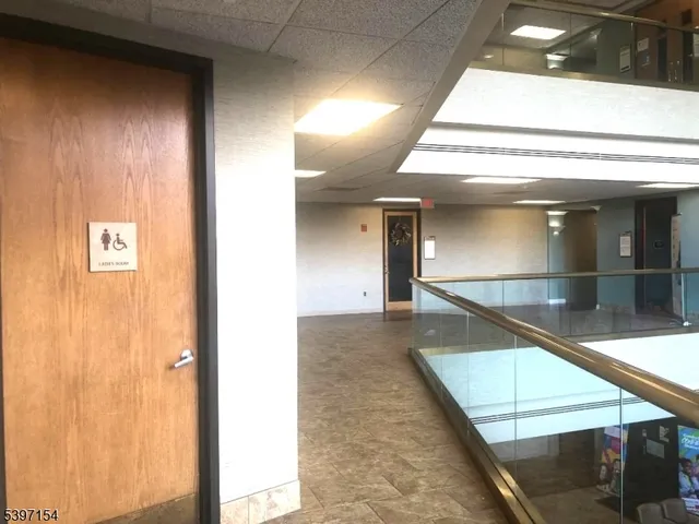 a view of building along the road and covered with trees