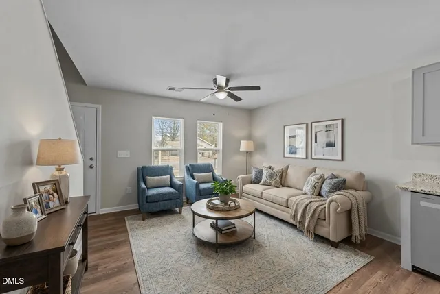 a living room with furniture and a chandelier