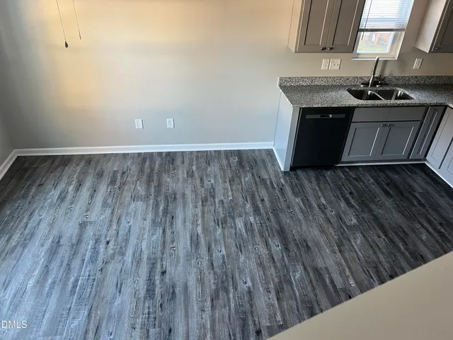 a room with wooden floor and a sink