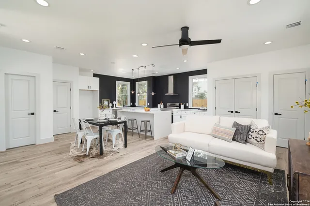 a living room with furniture and a wooden floor