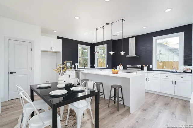 a kitchen with sink a stove and cabinets