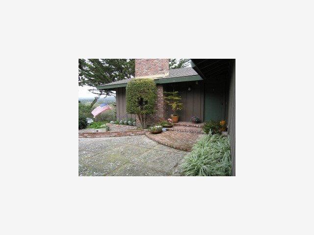 2955 Ribera Road Carmel, CA 93923 - Photo 1 of 9 a picture of a bench in front of building