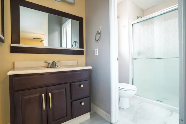 a bathroom with a sink toilet a mirror and vanity