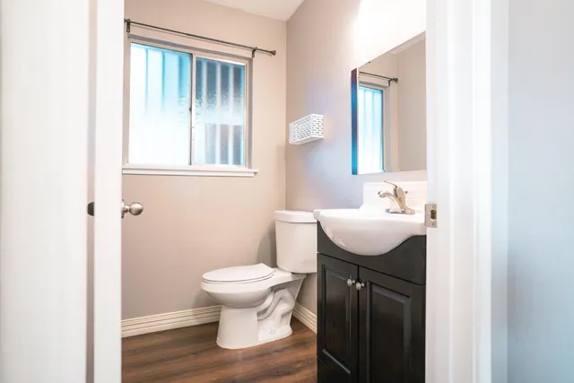 a bathroom with a sink a toilet and mirror