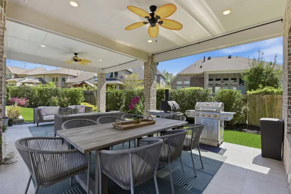 a view of a dining room with furniture wooden floor and garden view