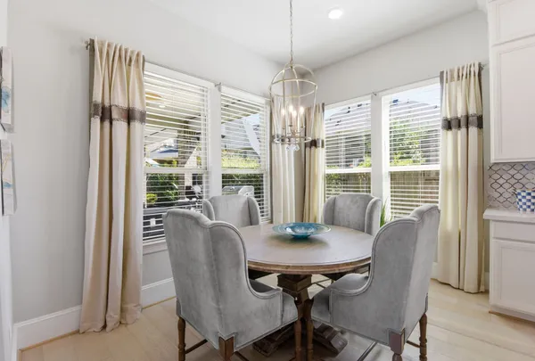 a kitchen with stainless steel appliances kitchen island granite countertop a table and chairs in it